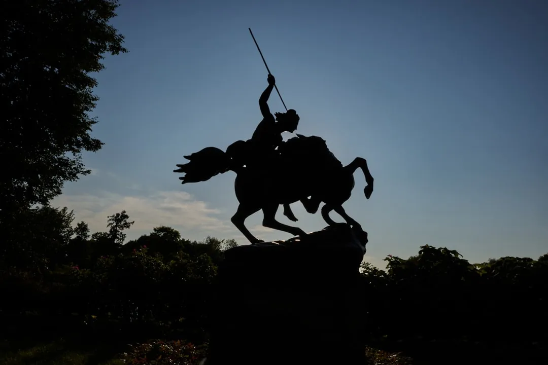 A statue of a man riding a horse holding a sword