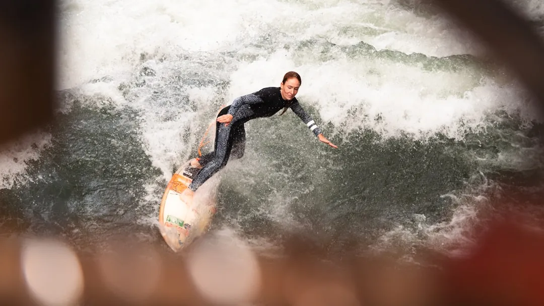 A man riding a wave on top of a surfboard