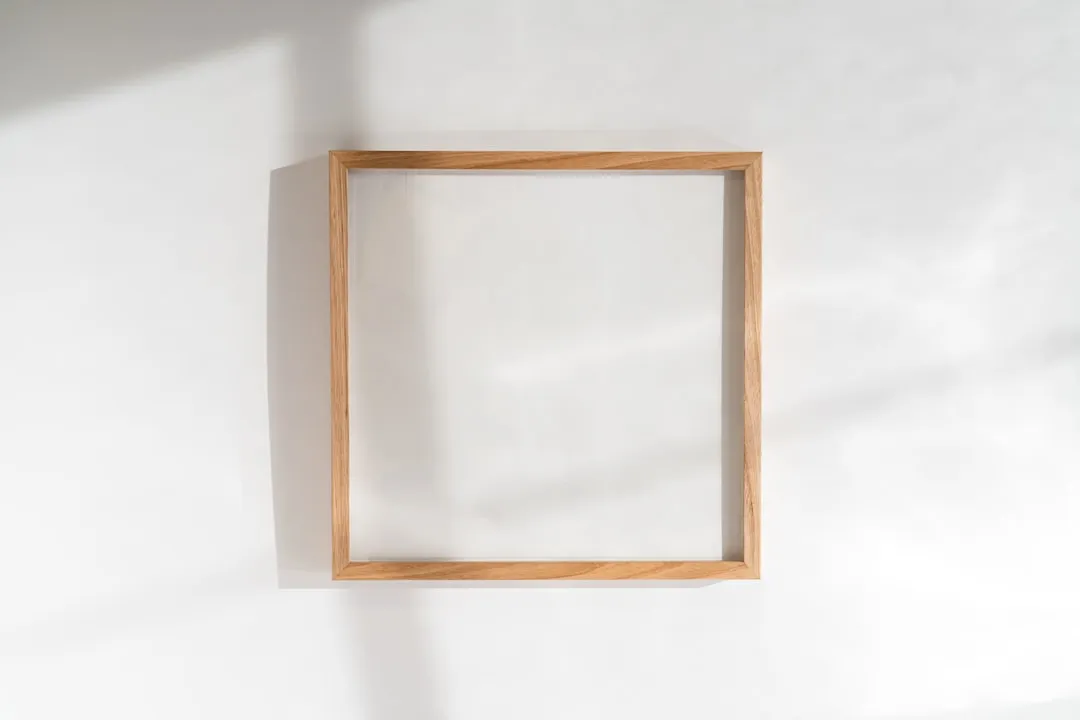 a square wooden frame hanging on a wall